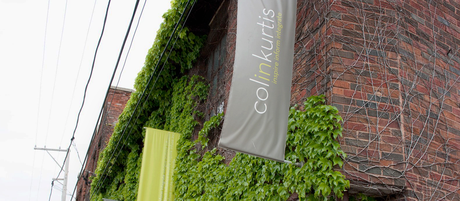 Brick office building with ColinKurtis banner