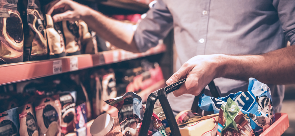 Man grocery shopping with basket