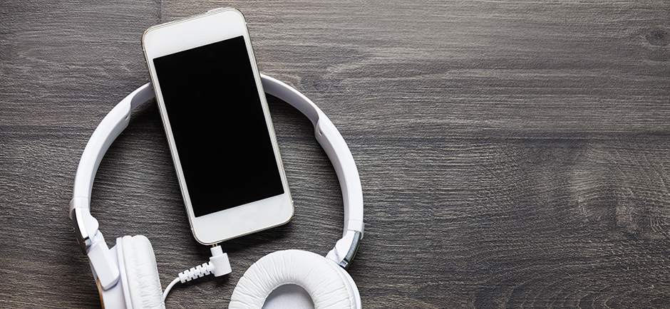 headphones and phone on wood background