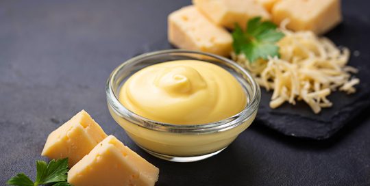 various styles of cheese on a black table