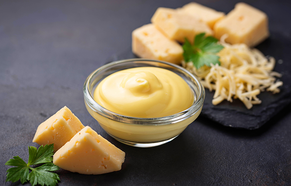 various styles of cheese on a black table